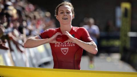 Georgia Taylor-Brown gestures as she celebrates crossing the finish line.