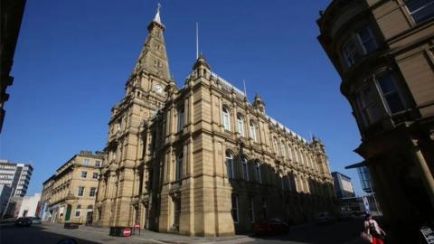 Calderdale Council building against a blue sky.