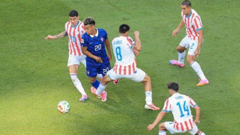 Diego Gomez of Paraguay fouls Desire Doue of France during the World Cup game in Philadelphia