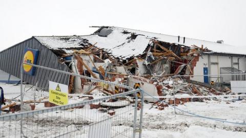 A Lidl supermarket was bulldozed with a digger during the incident