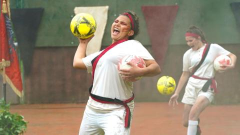 Football player about to throw a yellow ball aggressively
