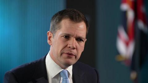 Jenrick with blue background