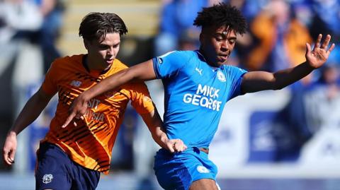 James Dornelly (right) of Peterborough United and Cian Ashford of Cardiff City compete for the ball
