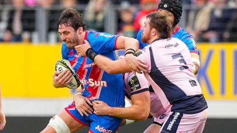 Paul Gabrillagues of Stade Francais is tackled by Cardiff prop Sam Wainwright