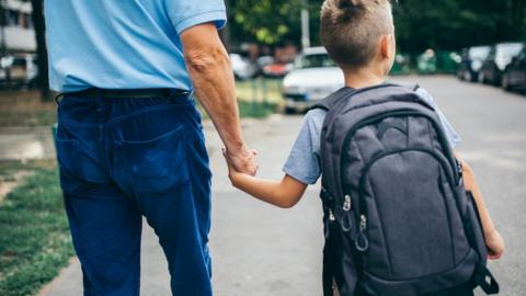Stock image of boy walking to school