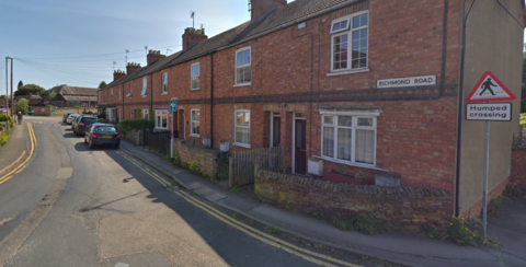 A row of terraced houses next to a road 