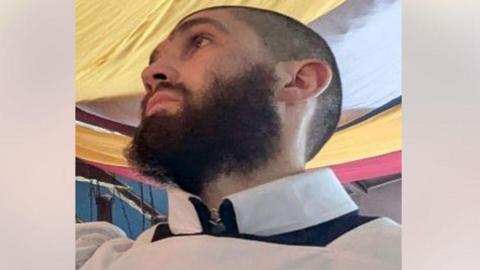 Justin Evans, a man with a black beard.