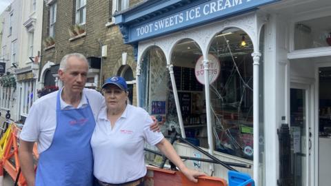 couple standing outside shop