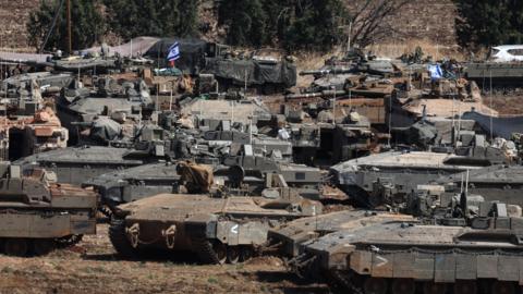 Dozens of Israeli tanks gathered at an undisclosed location in northern Israel