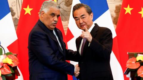 China's Foreign Minister Wang Yi (right) shakes hands with Dominican Republic's Chancellor Miguel Vargas