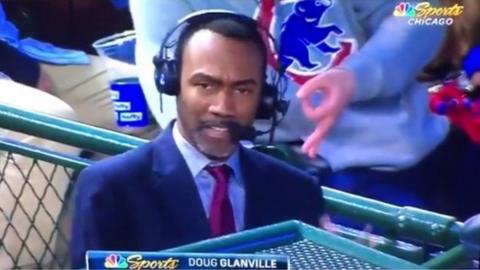 Doug Glanville reporting as a fan makes the upside down 'OK' hand gesture behind him