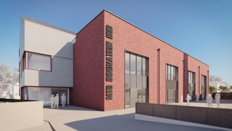 A computer generated view of how a mountain bike centre will look with a largely brick building and people milling about outside