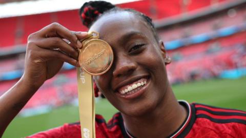 Melvine Malard of Manchester United poses for a photograph with her Adobe Women's FA Cup winners medal