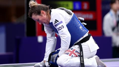 Jade Jones kneels down after losing in the first round of the Olympic taekwondo competition