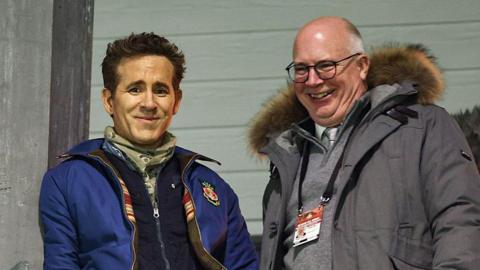 Shaun Harvey and Ryan Reynolds watch a game at the Stok Cae Ras. 