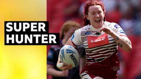 Wigan Warriors' Eva Hunter smiling as she scores a try 