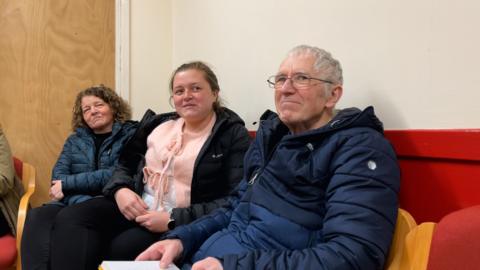 Katie Ghreumach sa pàrantan nan suidhe a' gabhail pàirt sa chlas seinn.