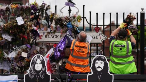Birmingham City Council workers and volunteers removing flowers and tributes left for Ozzy Osbourne at the Black Sabbath Bridge in Birmingham