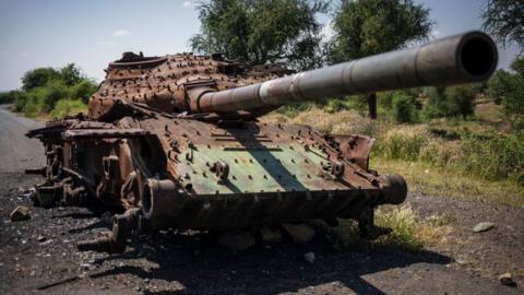 The charred remainins of a T-72 tank lay on the road that connects Shiraro to Shire on October 12, 2024