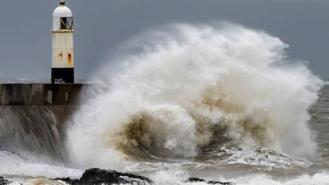 PORTHCAWL, WALES - AUGUST 5: Waves crash against the harbour wall at Porthcawl seafront on August 5, 2023 in Porthcawl, Wales. The Met Office have issued an amber weather warning for wind as Storm Antoni hits