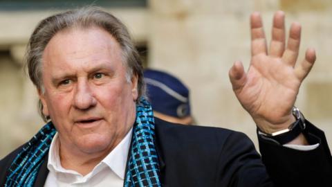 Gérard Depardieu waving as he arrives at Brussels Town Hall for a film festival ceremony in 2018