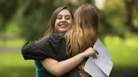 Holly Cuttiford hugs her mum after receiving her A Level results at Ffynone House School on August 13, 2020 in Swansea