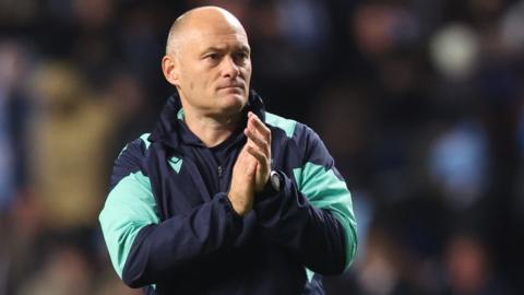 Stoke City manager Alex Neil applauds the crowd after a game