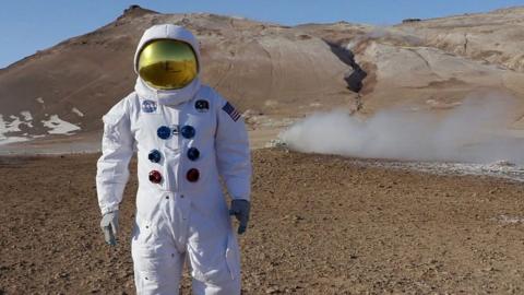 Man in astronaut suit in Iceland