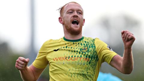 Sion Bradley celebrates after scoring one of his three goals for Caernarfon