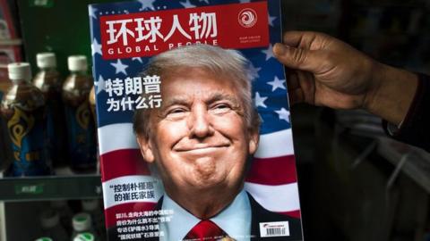 A copy of the local Chinese magazine Global People with a cover story that translates to "Why did Trump win" is seen with a front cover portrait of US president-elect Donald Trump at a news stand in Shanghai on November 14, 2016