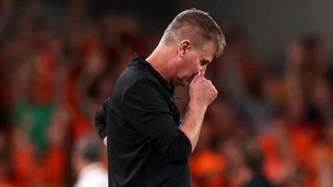 A dejected Stephen Kenny looks down at the ground during the Republic of Ireland's defeat by the Netherlands