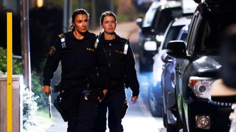 Police patrol at the scene after a shooting in Jordbro, Sweden, 28 September 2023