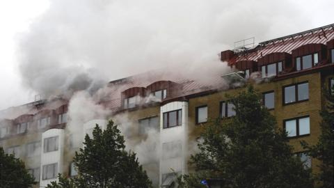 Smoke comes out of windows after an explosion hit an apartment building in Annedal, central Gothenburg, Sweden September 28, 2021