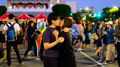 Lesbian couple celebrate Pride with kiss