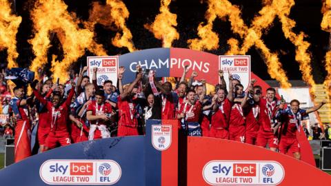 Leyton Orient celebrate with the League Two trophy