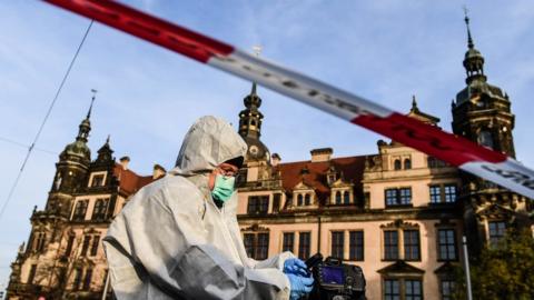 A Police Forensics officer investigates the area near the Dresden museum