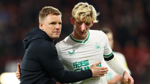 Newcastle manager Eddie Howe (left) embraces Anthony Gordon (right) who is wearing the white and green third kit