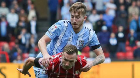 Andreas Weimann (front) of Bristol City tangles with Coventry City's Josh Eccles