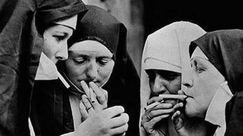 Meme of nuns smoking with Russian caption that says: “Quick, while God isn’t looking!”