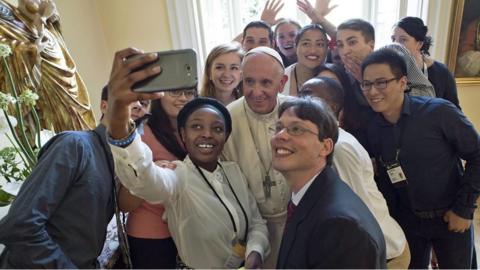 Pope Francis taking a selfie with young people