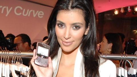 Kim Kardashian holding a Blackberry phone