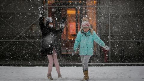 Children play in the snow