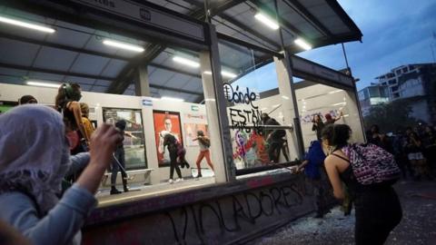 Women vandalise a Metrobus station during a protest in Mexico City