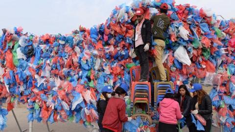 Volunteers make a sculpture out of plastic bags in Kathmandu