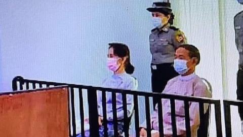 Aung San Suu Kyi in a makeshift courtroom with two other former leaders, 24 May 2021