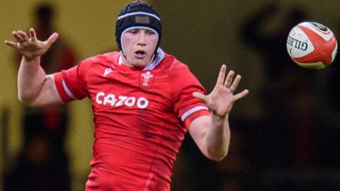 Seb Davies sends the ball back from a Wales line-out