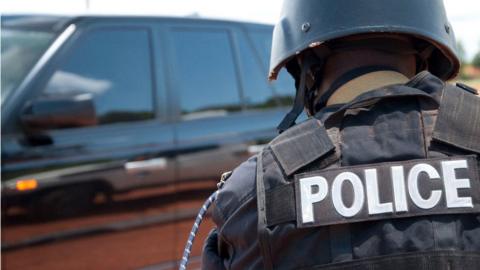 A photo of a Uganda police officer wearing a protective jacket