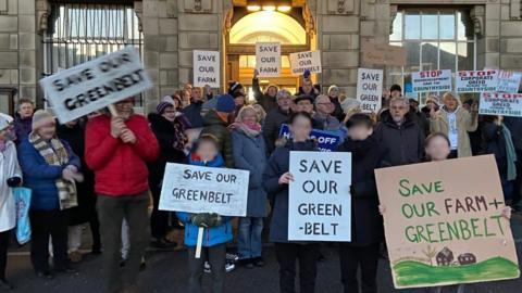 Protesters outside Wallasey Town Hall over the plans