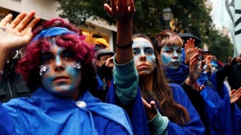 People attend an Extinction Rebellion protest against climate change in Madrid