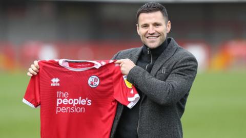 Mark Wright holds up Crawley Town shirt